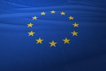 The European Union flag is flying in the air, the background is clouds and the blue sky