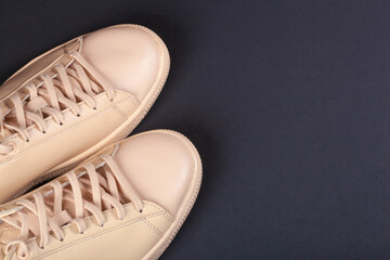 Close-up shot of beige beige sneakers with beige laces