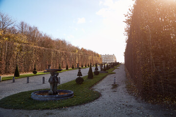 Versailles gardens with no visitors and people in autumn season.