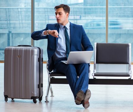 Businessman waiting at the airport for his plane in business cla
