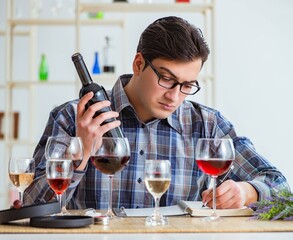 Professional sommelier tasting red wine