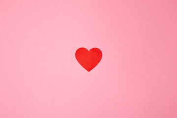 Overhead shot of a red heart on a pink background. Background for Valentine's day. Horizontal photography