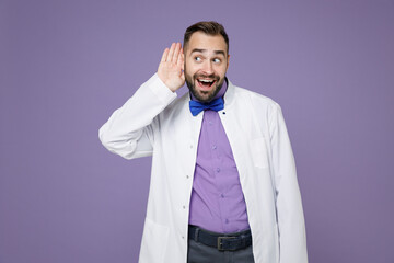 Curious excited young bearded doctor man in white medical gown try to hear you overhear listening...