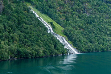 Fototapeta na wymiar large waterfall over a fjord in northern norway