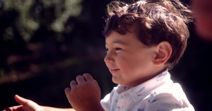 Happy little boy throwing confetti on birthday party