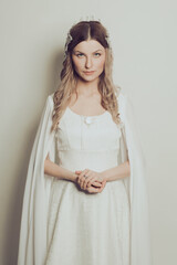 Attractive woman in white dress on white background