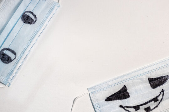 Protective medical facial blue masks with drawn scary halloween faces.