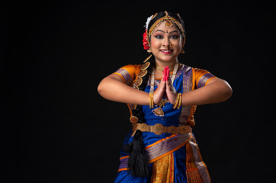 Kuchipudi dancer greeting with a smile on her face	