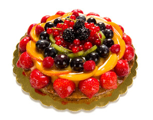 fruit cake richly decorated with many kinds of fruits, isolate on white
