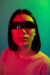 Young asian woman wearing smart glasses on colorful background - Diverse young female wearing sci-fi eye glasses isolated on background