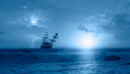 Silhouette of sailing old ship in a stormy sea,  amazing lightning in the background 