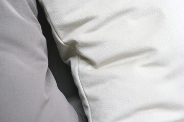Soft decorative pillows in beige shades. Production of upholstered furniture, details. Close-up photos, selective focus.
