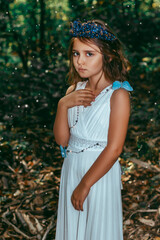 Cute little princess girl with blue butterflies in the forest. Art processing