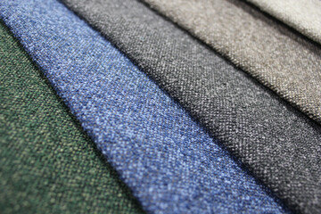 Samples of furniture fabric. Production of upholstered furniture, details. Close-up photos, selective focus.