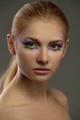 portrait of a beautiful girl with skillful bright fantasy makeup