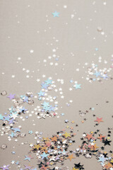 Sparkling and holographic stars on silver background. Festive concept. Macro.