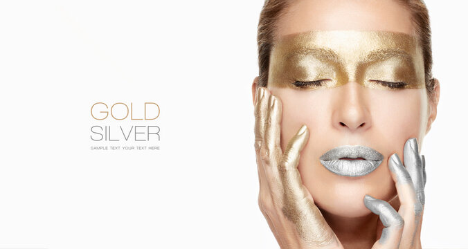 Beauty and makeup concept. Beautiful model girl with gold and silver makeup in a close-up portrait