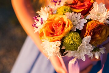 A bouquet of flowers in a basket in the sun