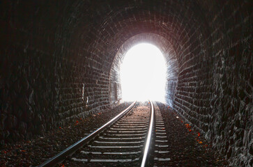 Naklejka premium At the end of the railway tunnel with light 
