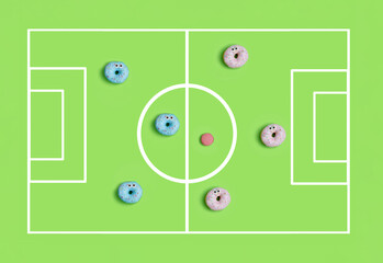 Funny colorful donuts playing football. Kids party time concept