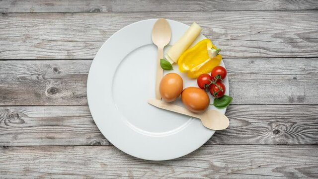 Interval fasting diet represented with plate, cuttlery and products