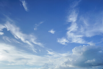 Summer sky is bright blue. There are clouds floating through. Feel relax when looking. See the sun on the sun.