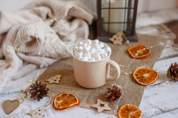 Christmas composition, mug with cocoa and marmalade on a wooden background