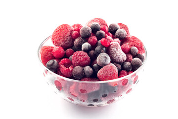 Frozen berries in a glass bowl, isolated on white, horizontal