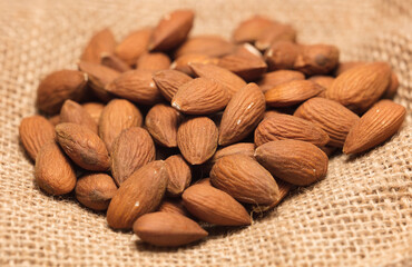 almonds with raffia sack, white background