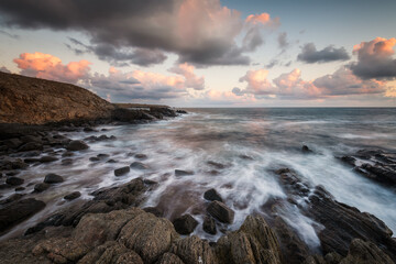 Obraz premium Stormy sea with sunrise sky at a rocky coastline, the Black Sea coast, Bulgaria