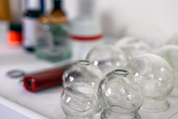 Acupuncture glass cups on the table with blured background.