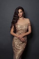 Fototapeta premium Stylish woman with long perfect hair and makeup on black background