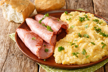 English pea pudding with fried ham served with bread close-up in a plate on the table. horizontal
