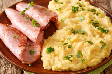 Split Pea porridge with fried ham and parsley close-up in a plate on the table. horizontal