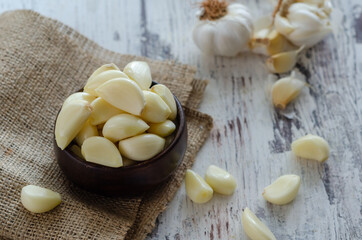 Peeled fresh garlic on kitchen table.