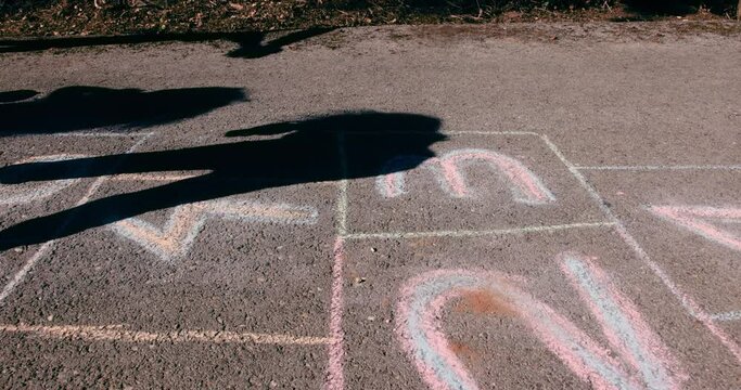 Kids jumping and playing hopscotch on school playground