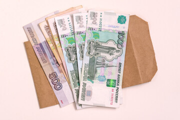 Money Russia. A stack of cash and an envelope on a white background. The concept of salary in an envelope. Illegal business profits.