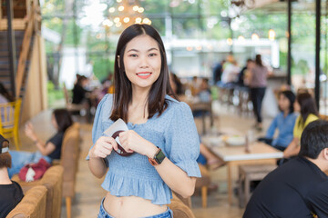 Business asian women sitting relax in cafe use smartphone communication