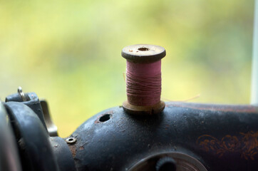 Wooden spool with thread on a sewing machine