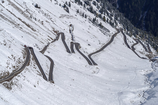 Winding Road Towards Stelvio Pass In The Snowy Landscape, High Angle View, Italy