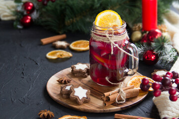 Christmas hot mulled wine with cinnamon cardamom and anise. Dark vintage dirty background. Creative atmospheric decoration