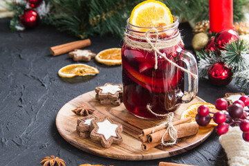 Christmas hot mulled wine with cinnamon cardamom and anise. Dark vintage dirty background. Creative...