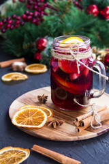 Christmas hot mulled wine with cinnamon cardamom and anise. Dark vintage dirty background. Creative...