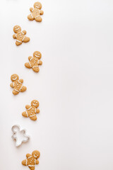 Homemade gingerbread cookies on white background. Christmas, winter, new year composition. Flat lay, top view, copy space
