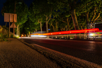 A long exposure shot of a car driving at night