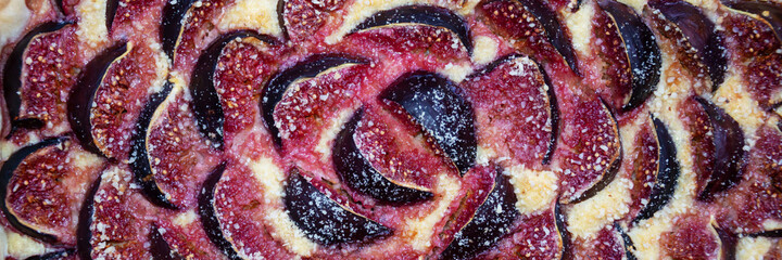Panoramic background of a fig tart close up. Fall fruit dessert web banner
