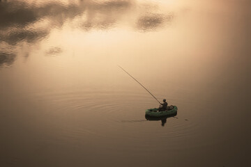 fisherman in a rubber boat on the water