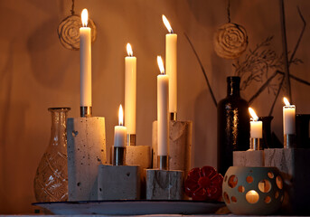 Beautiful white candles burning in dark 