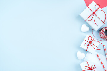 Fototapeta na wymiar Valentine's Day greeting design concept - Top view of gift box on bright blue background.
