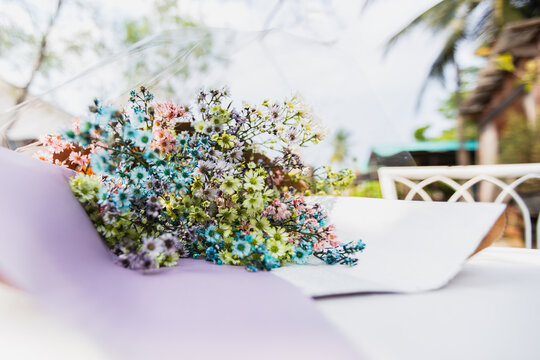Bouquet of dried multicolor flowers lying on table.